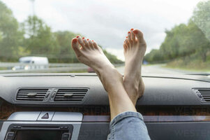 mature-woman-with-feet-up-on-car-dashboard-CHPF00788.jpeg